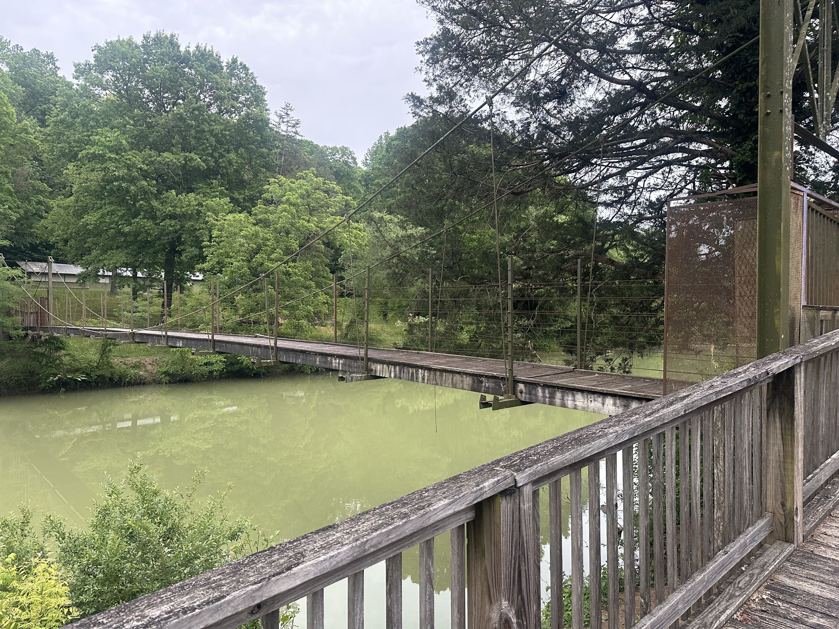 The swinging bridge over the lake at Camp Glancy, a retreat center on the Little Sequatchie River between Jasper and Whitwell